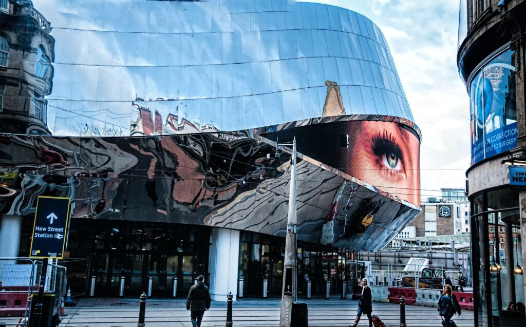 A large reflective building, reflecting an eye